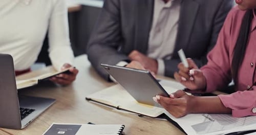 Business Team Collaborating with Tablet Technology in Office