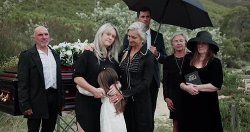 Sad, people and hug child at graveyard for funeral ceremony, burial service and mourning loss