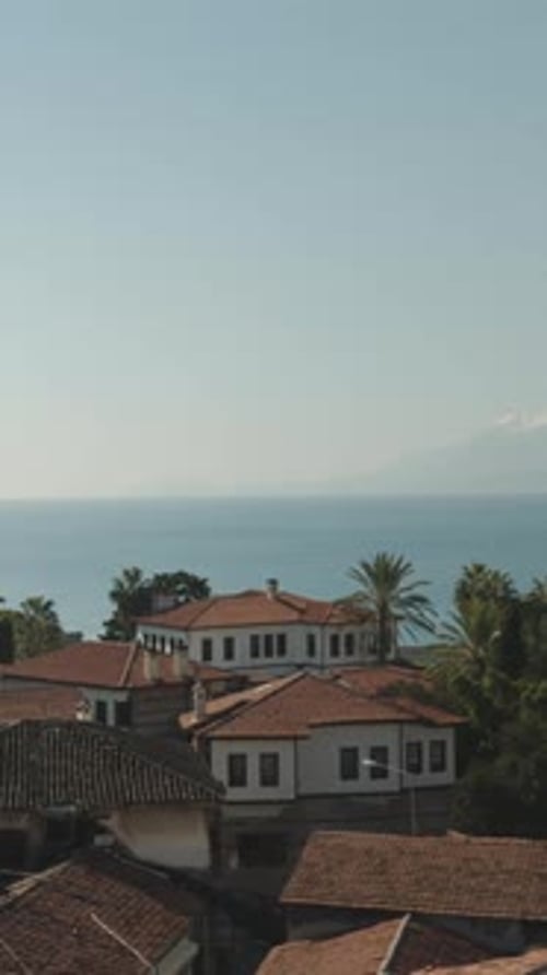 Panorama of the old town on the seashore on the mountain. Red tiles on the roofs.