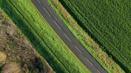 Aerial view of car on road near fields, United Kingdom.