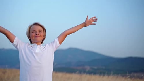 Joyful Child with Wind Turbine at Sunset