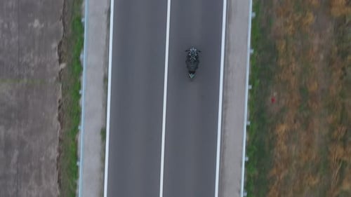 Top View to Motorcyclist Racing His Motorcycle on Country Road Man Drive Bike During Trip Aerial