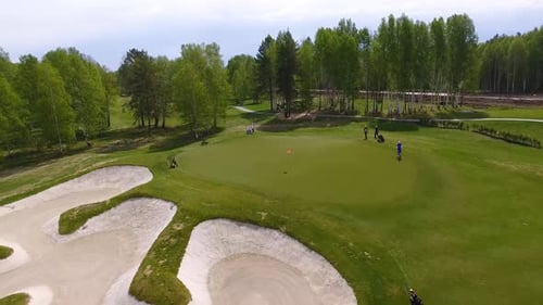 A Picturesque Panoramic View of a Scenic Golf Course Featuring Golfers Playing on the Green