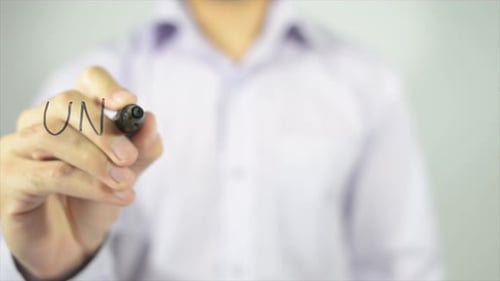 Writing The Word Unsatisfied On Glass Surface