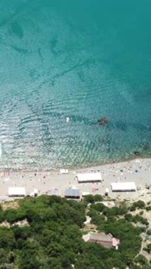 Aerial View on Summer Beach Swimming People in Sea Bay with Transparent Blue Water and Volcanic