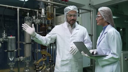 Two Scientist in Professional Uniform Working in Curative Laboratory