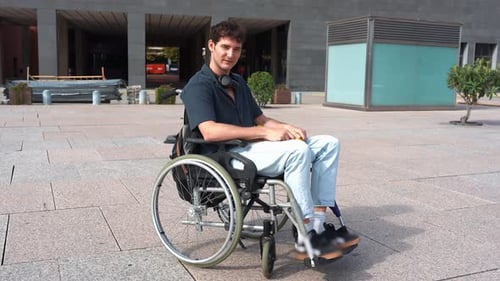 Disabled Student in Wheelchair Moving on University Campus