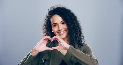 Smiling Woman Makes Heart Shape With Hands