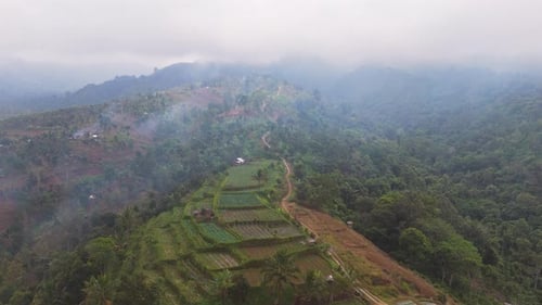 Aerial View of Misty Mountain Farmland in Lombok Indonesia