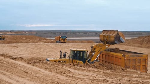 Excavator Loads Earth Into Trucks Industrial Construction Preparing the Area for Construction