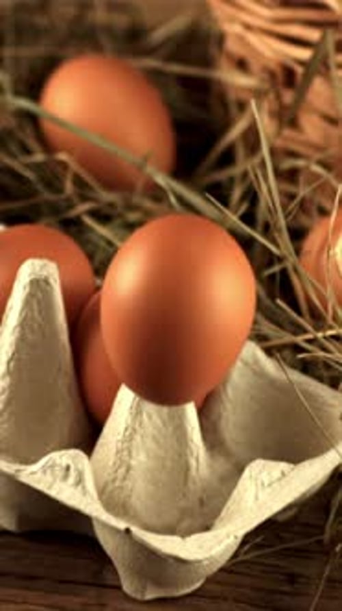Super Slow Motion Egg Falls Into a Cardboard Box on the Table Filmed on a Highspeed Camera at 1000