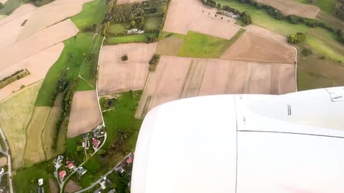 Countryside Fields, Town Houses, And Jet Engine Seen Through The Airplane Window. - POV