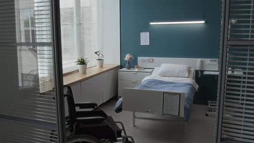 Cozy Hospital Room with Single Bed, Bedside Table, IV Stand and Wheelchair