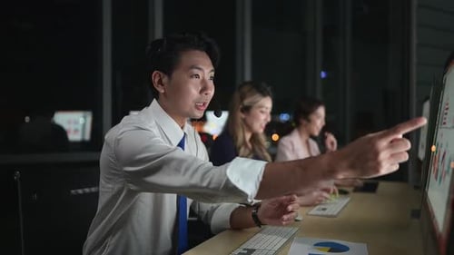 Group of broker international stock traders wearing headset working actively at night in office,