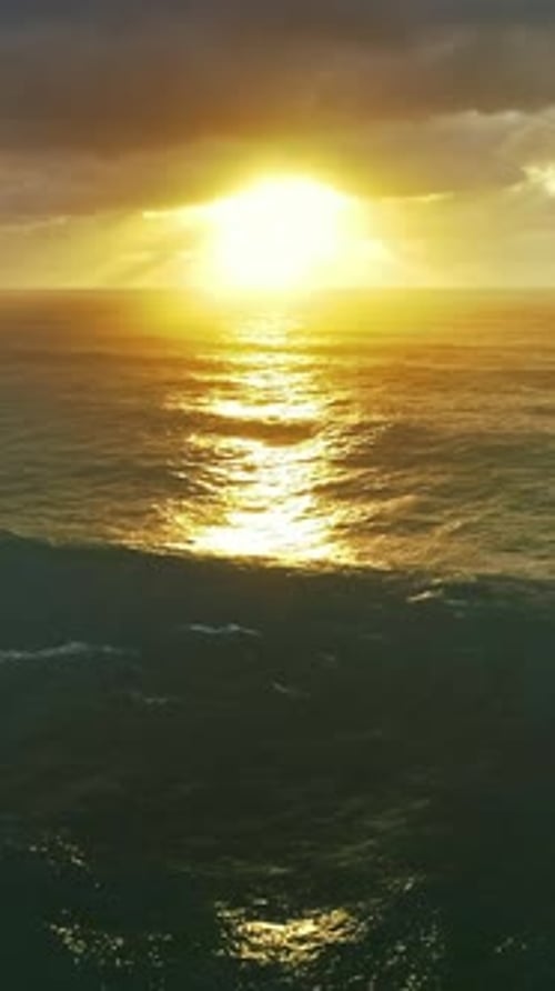 Aerial view on big waves and dramatic sunset sky