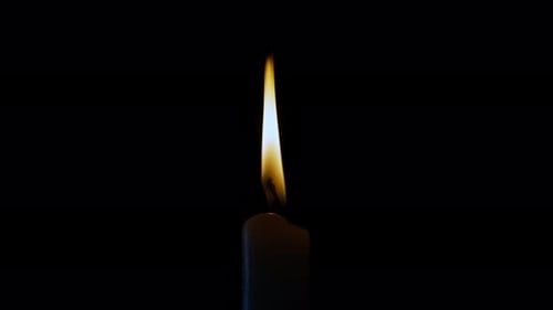 The central composition of a burning candle close-up.