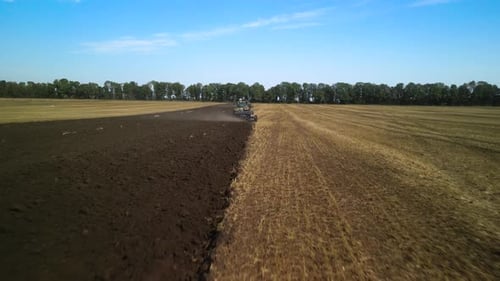 Tractors plowing the field in Ukraine