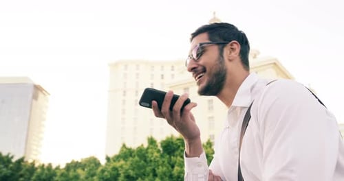 4k video footage of a handsome young businessman using a mobile phone in the city