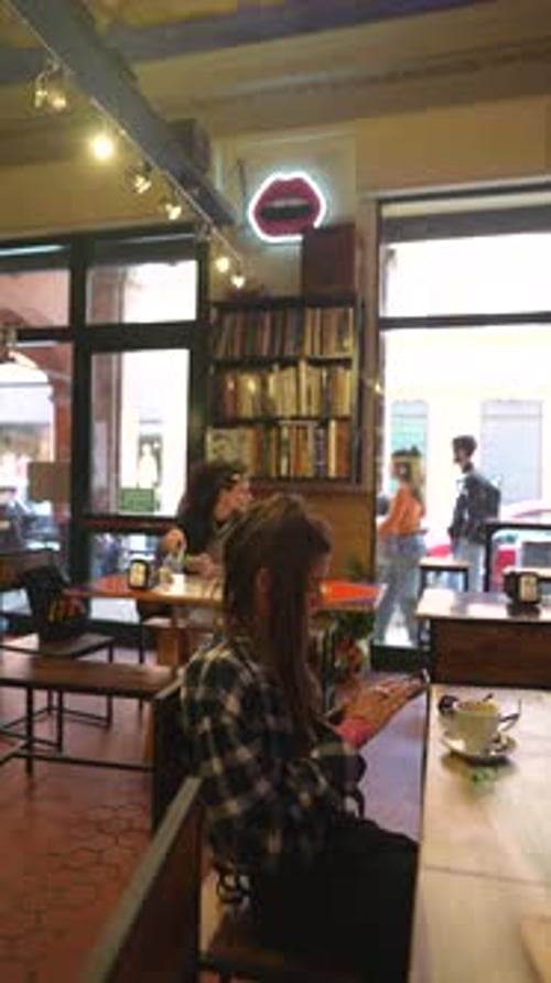 Woman Using Smartphone in Urban Cafe