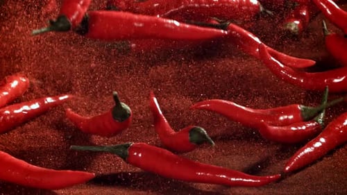 Red Chili Pepper in Flight with Ground Pepper Filmed on a Highspeed Camera at 1000 Fps