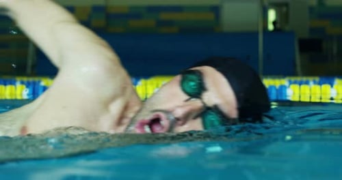 nice attractive and young man in the empty swimming pool in slow motion