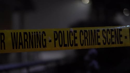 Police Crime Scene Tape With Flashing Lights in Snowy Winter Night, Close Up