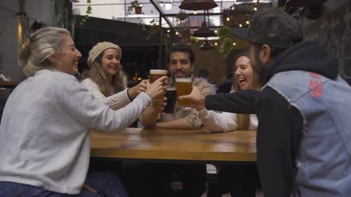 Friends Toasting Drinks Together at Urban Bar