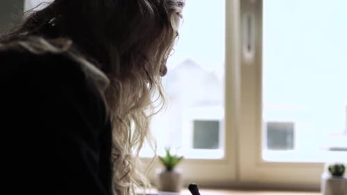 Young Woman Working on Her Laptop Computer in Coffee Shop