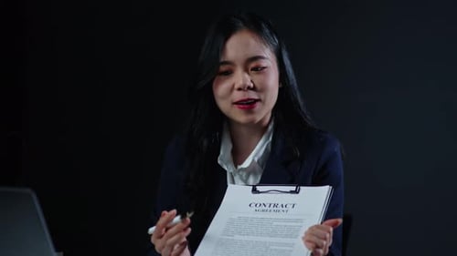 Young Adult Woman Presenting Contract Agreement at Desk