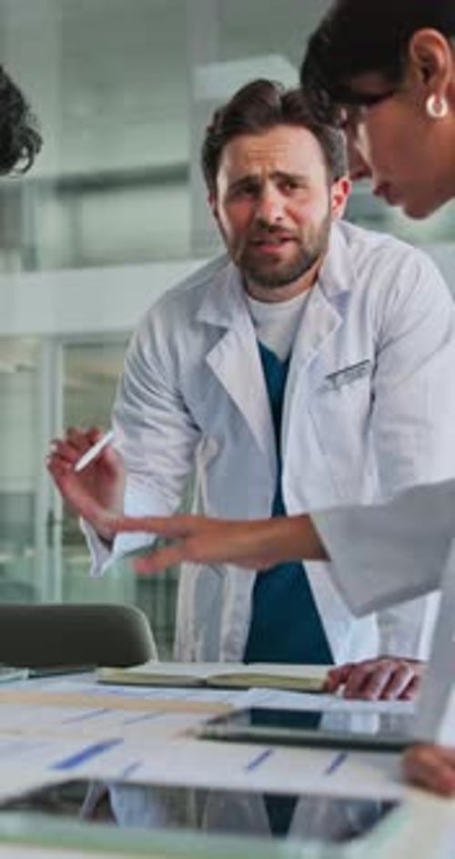 Doctor, team and meeting with records in clinic to review test results, health update or feedback