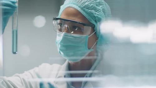 Researcher Mixing Sample in Test Tube in Lab