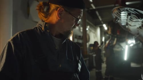 Mature Auto Mechanic Using Digital Tablet