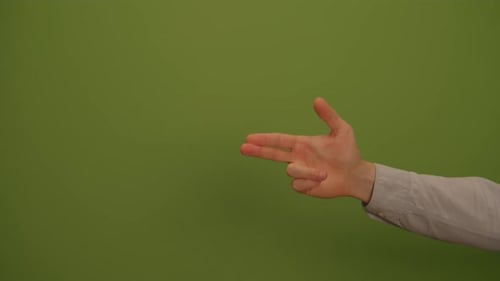 An Expressive Hand Gesture Performed Against a Vibrant Green Screen Background for Visual Impact