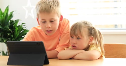 Cute Brother and Sister Joyfully Use the Tablet Together Digital Technologies