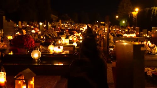 Slovakian Nighttime Cemetery Illumined By Lamplights With Bouquet Of Flowers On Tombs- Steady Shot