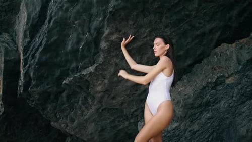 Sensual Woman on Rocky Shoreline