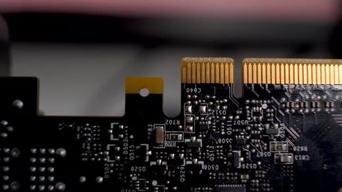 Close-up of a graphics card, the PCB with its array of yellow pin connectors which seamlessly integr