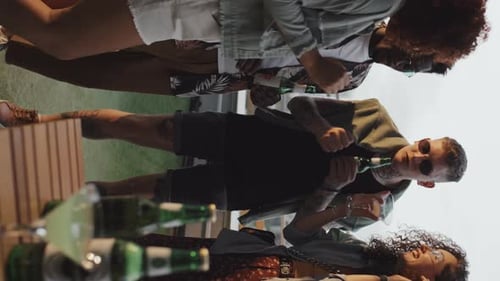Young Men And Women Dancing At Party In Evening