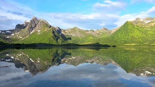 A Serene Lake Surrounded By Mountains Reflects Their Beauty in Its Calm Waters Creating a