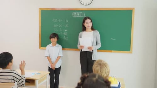Group of student learn with teacher in classroom at elementary school.