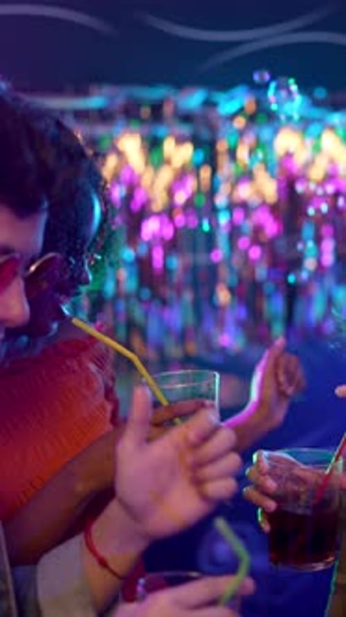 Friends Enjoying Drinks and Dancing at a Nightclub