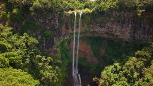 Aerial View of Spectacular Chamarel Waterfall Plunging From Verdant Cliff Into Shadowy Jungle Depths