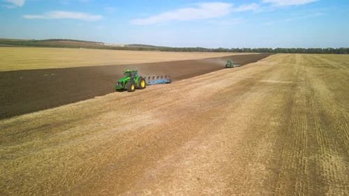 Tractors plowing the field in Ukraine