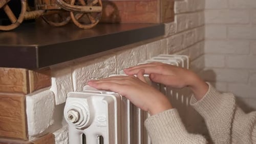 Child hands on heating battery.