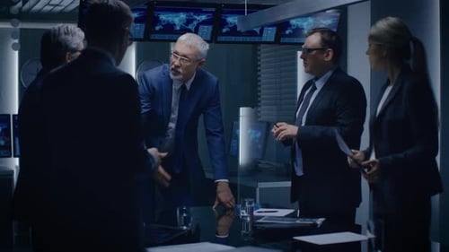 Business Team Meeting at Conference Table Discussing Plans