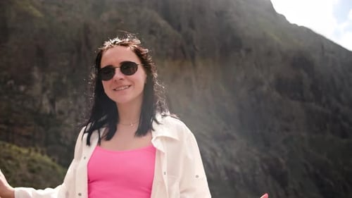 Smiling Woman in front of Mountain Landscape