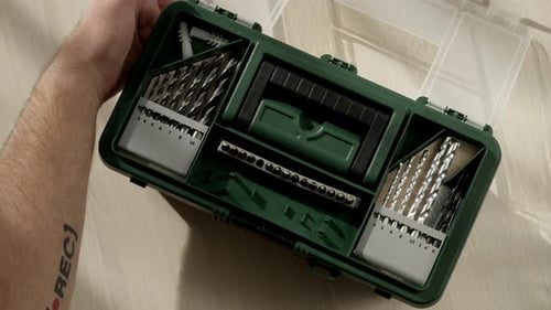 Man Put Wood Drill in It Place in Green Suitcase with Tools