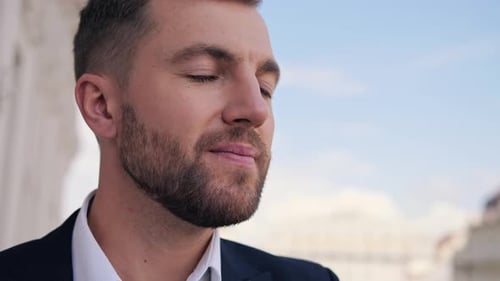 Portrait of Confident Businessman Man Raises His Head Enjoys Fresh Air in Hotel