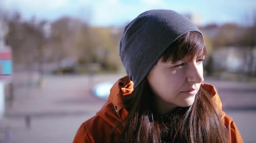 Autumnal Farewell Woman Portrait Gazing Into the Camera Putting on Hood and Exiting the Frame