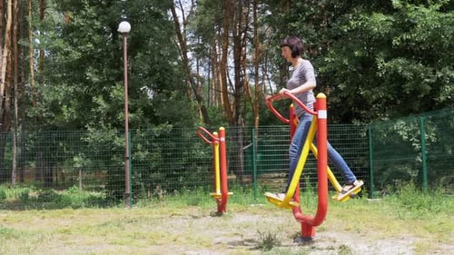 Woman Exercising on Outdoor Fitness Equipment
